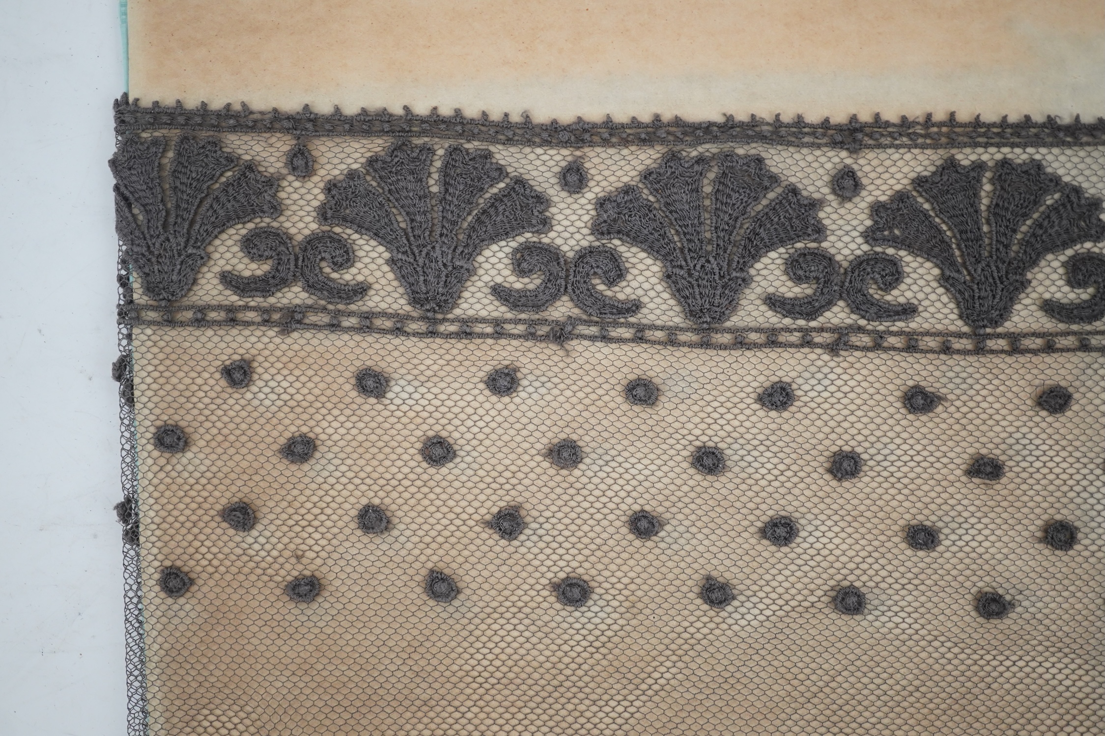 An unusual 19th century decorative length of charcoal grey machine furnishing lace, attributed to Christopher Dresser, together with a similar grey lace bonnet veil, both possibly Nottingham lace, furnishing lace 300cm j